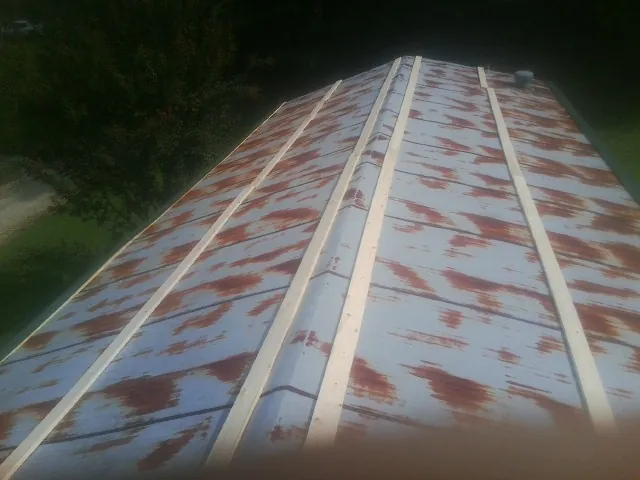 Rusted metal roof panels with new wood purlins before replacement — Storm Damage Roof Repair in Washingtonville by Roofing Brothers