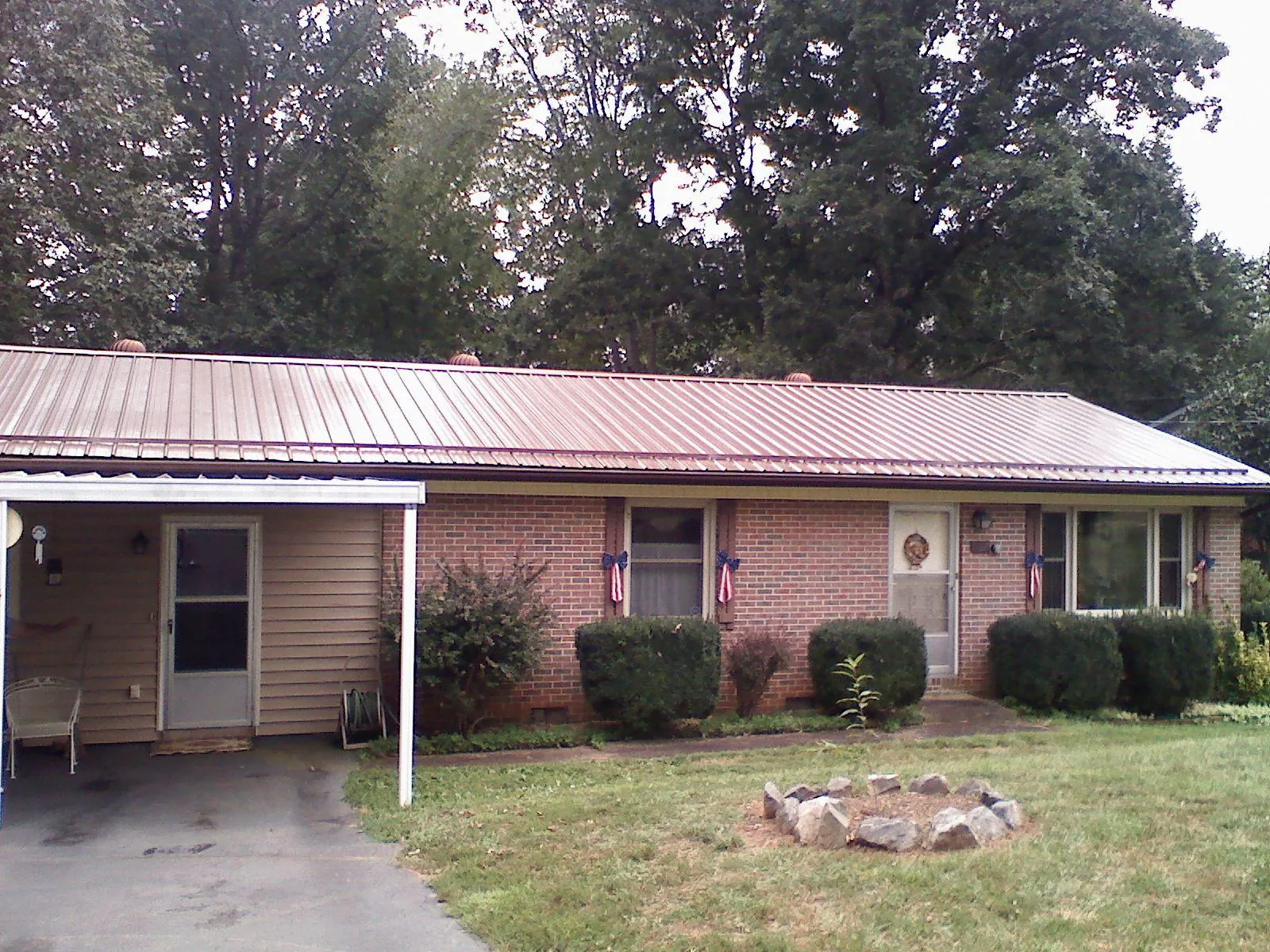 Bronze metal roof and carport on a brick ranch home — Roof Repair work by our crew in Washingtonville